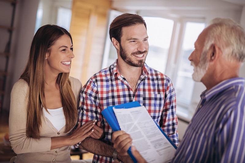 Realtor with couple closing on a property